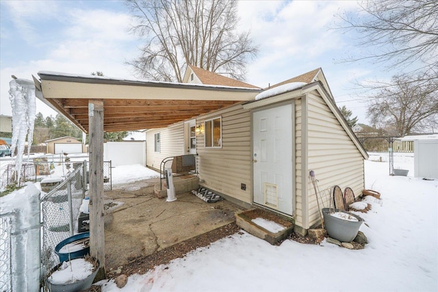 exterior space featuring an attached carport and fence