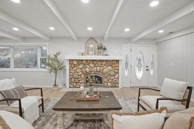 living room featuring light wood finished floors, baseboards, beamed ceiling, and recessed lighting