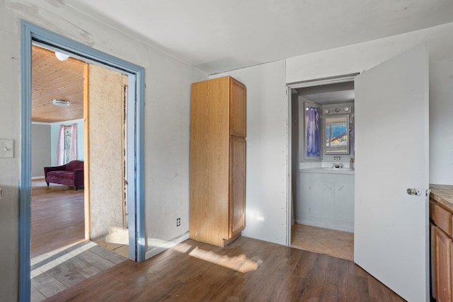 empty room with dark wood-style floors and a sink