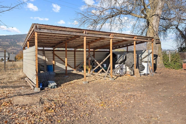 view of pole building featuring driveway and a detached carport