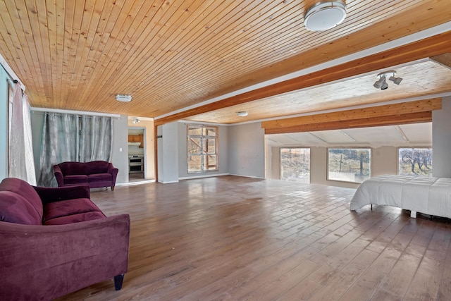 living room with wood ceiling, plenty of natural light, and wood finished floors