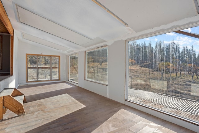 sunroom / solarium featuring vaulted ceiling and a wealth of natural light