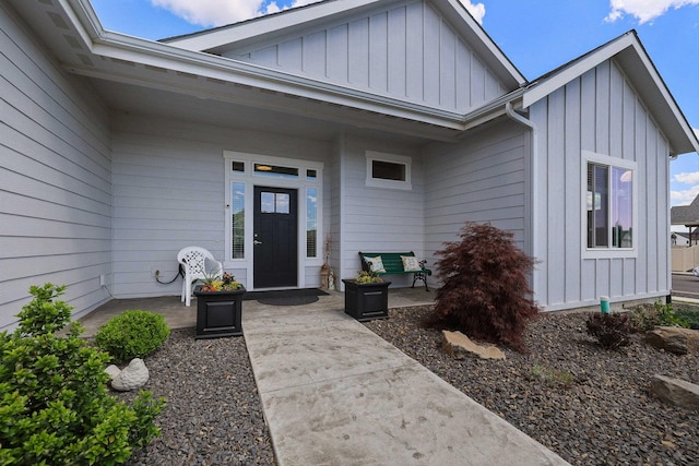 view of exterior entry with board and batten siding