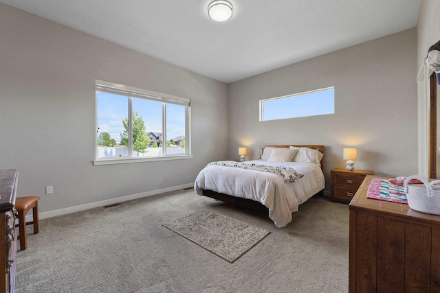 carpeted bedroom with visible vents and baseboards