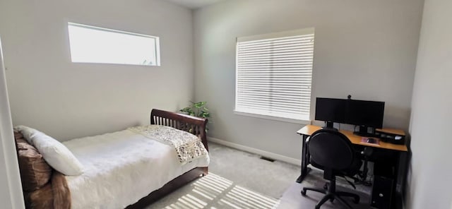 carpeted bedroom with visible vents and baseboards