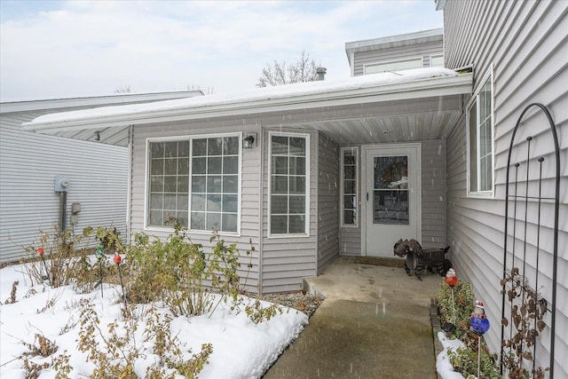 view of snow covered property entrance