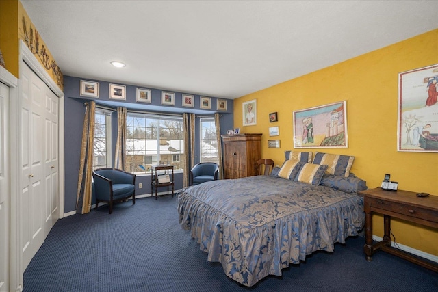 bedroom featuring dark carpet and baseboards