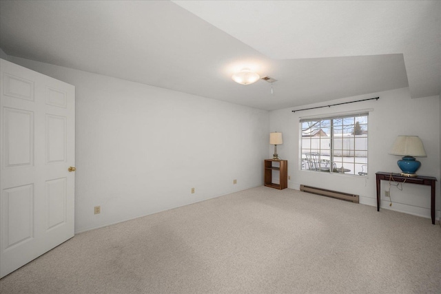 empty room featuring a baseboard heating unit, carpet floors, and visible vents