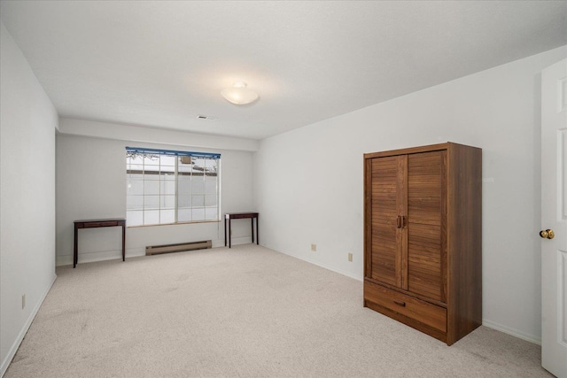 unfurnished room with light carpet, a baseboard radiator, visible vents, and baseboards