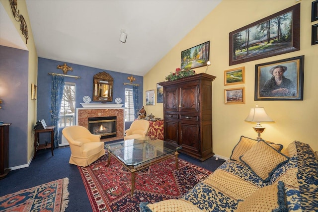 living room featuring lofted ceiling, dark carpet, baseboards, and a premium fireplace