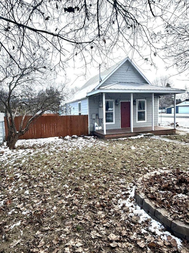 view of front of home with fence and a porch