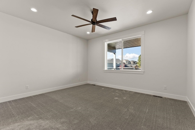 unfurnished room featuring recessed lighting, visible vents, dark carpet, a ceiling fan, and baseboards