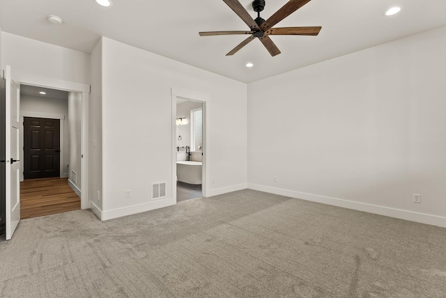 unfurnished bedroom featuring baseboards, recessed lighting, visible vents, and light colored carpet