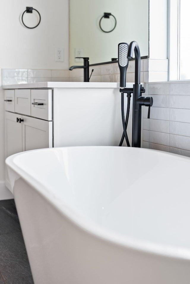 room details featuring a freestanding bath and vanity