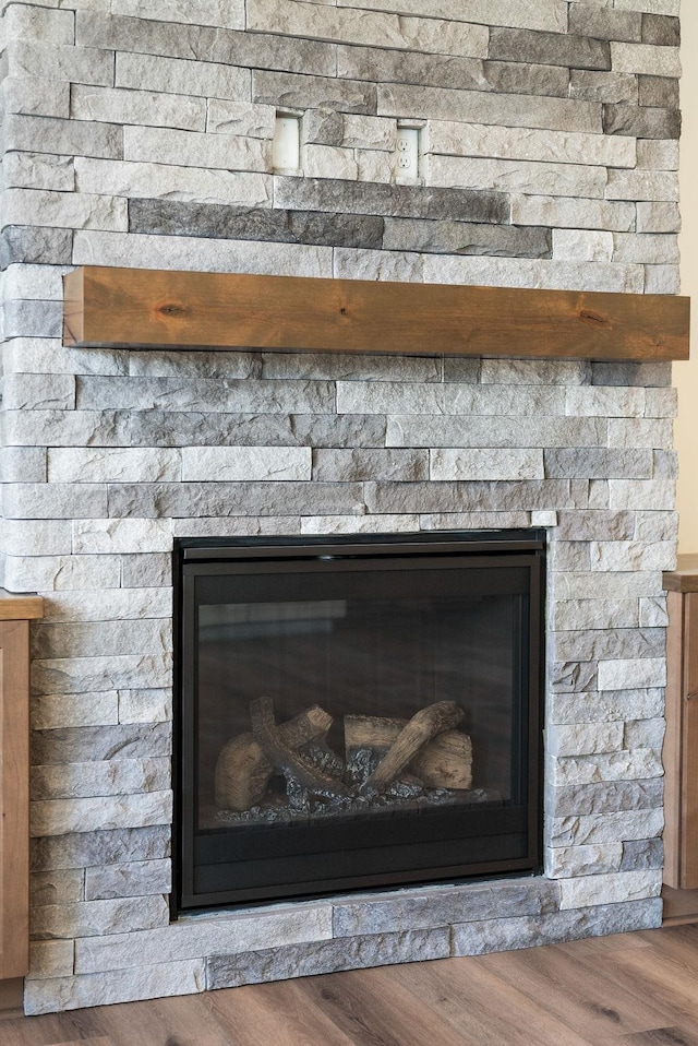 room details featuring a fireplace and wood finished floors