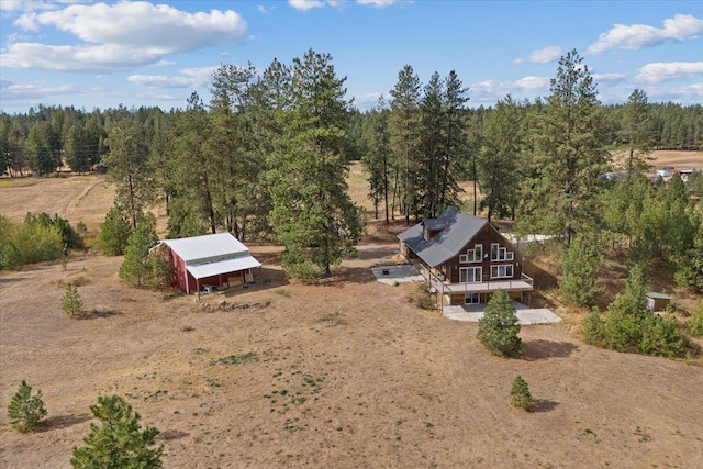 aerial view with a rural view and a wooded view