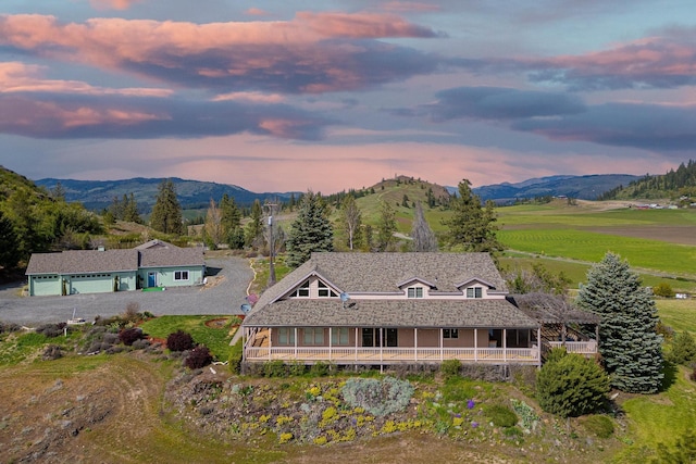 aerial view at dusk featuring a mountain view