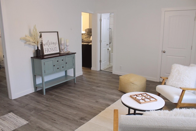 sitting room with dark wood-style floors and baseboards