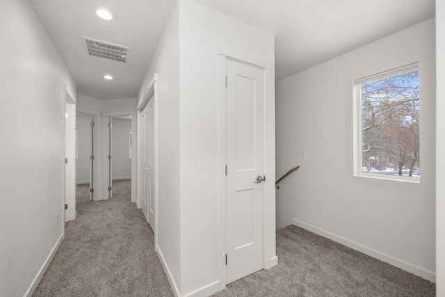 hall featuring recessed lighting, baseboards, visible vents, and light colored carpet