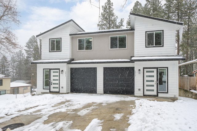 view of front of home featuring fence and an attached garage