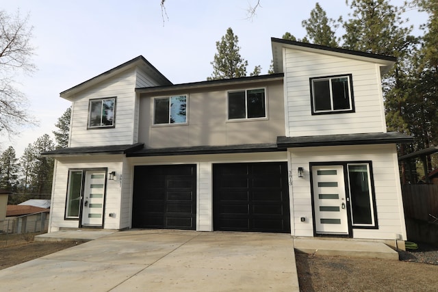 view of front of home featuring fence and an attached garage