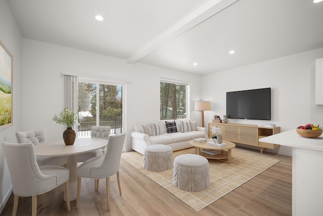 living area featuring beamed ceiling, light wood-style flooring, and recessed lighting