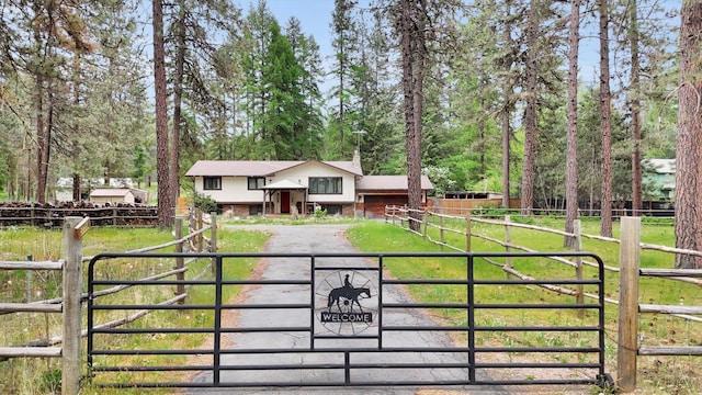27714 N Bear Lake Rd, Chattaroy, WA 99003 - view of front of home with a gate, asphalt driveway, and fence