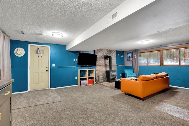 unfurnished living room with a wood stove, baseboards, visible vents, and carpet flooring