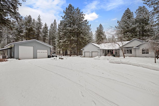 yard layered in snow with a garage