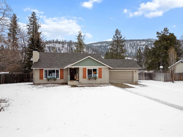 single story home featuring a garage, fence, and a chimney