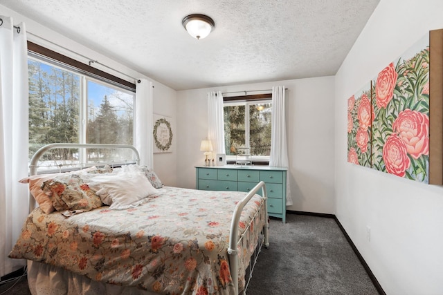bedroom featuring a textured ceiling, carpet flooring, and baseboards