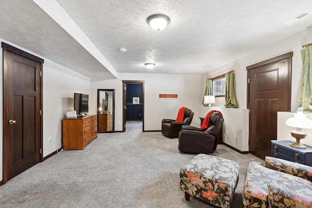 interior space featuring light carpet, visible vents, baseboards, and a textured ceiling