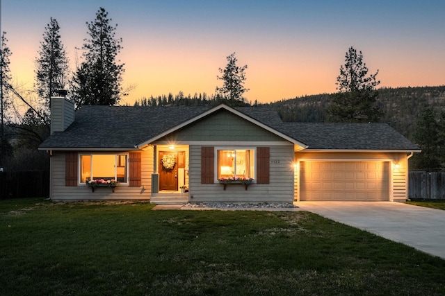 single story home featuring a lawn, fence, an attached garage, a chimney, and driveway