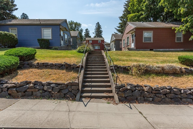 view of yard featuring a storage unit and stairway