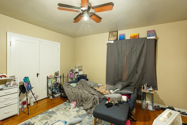 bedroom featuring dark wood-style floors and a ceiling fan