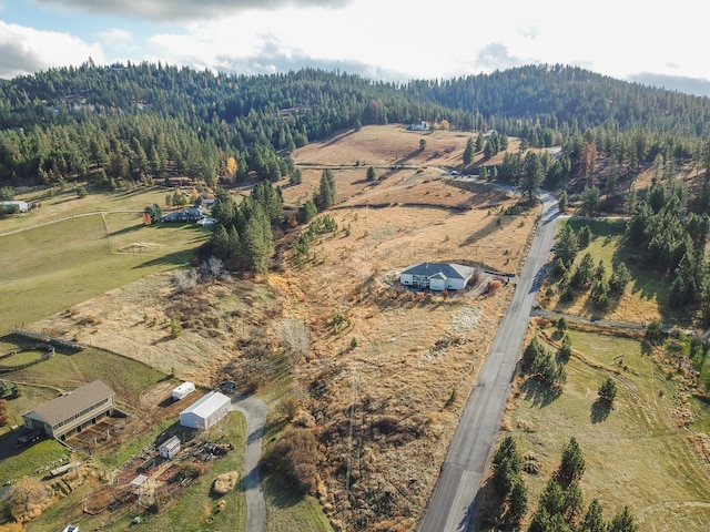 aerial view featuring a rural view and a view of trees