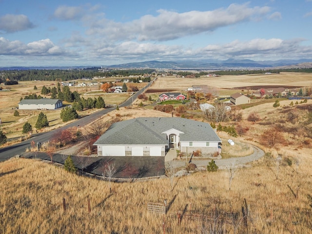 birds eye view of property with a mountain view and a rural view