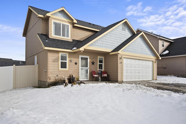 view of front of home featuring a garage, fence, and roof with shingles