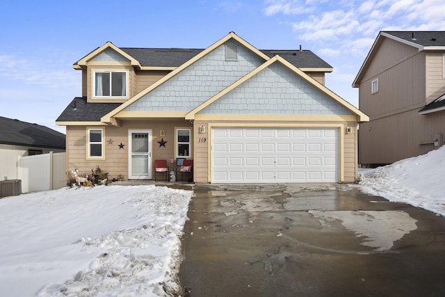 view of front of home featuring concrete driveway, roof with shingles, fence, and an attached garage