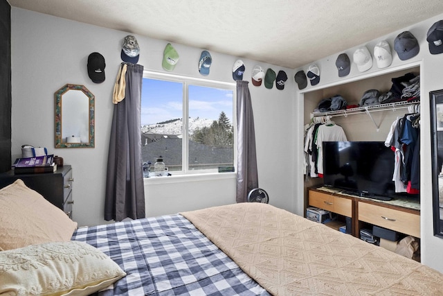 bedroom with a textured ceiling and a closet