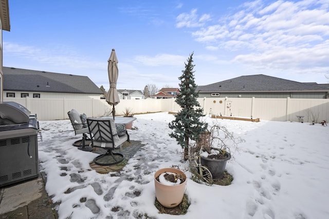 yard covered in snow featuring a fenced backyard