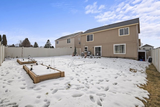 snow covered house featuring fence