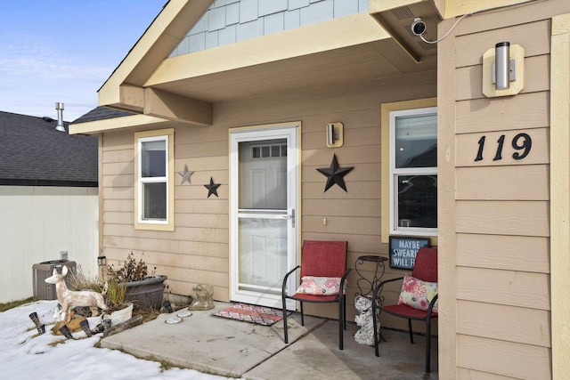 doorway to property featuring a patio area and cooling unit