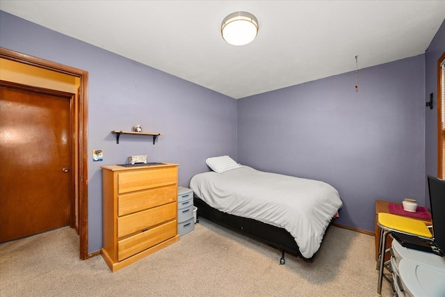 bedroom featuring light colored carpet and baseboards