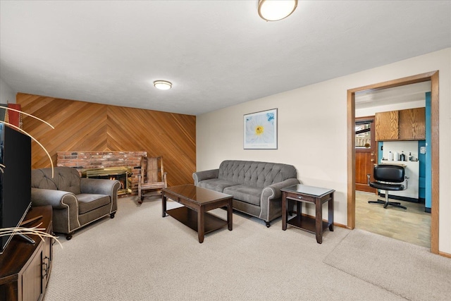 living room with light colored carpet, wood walls, and a fireplace