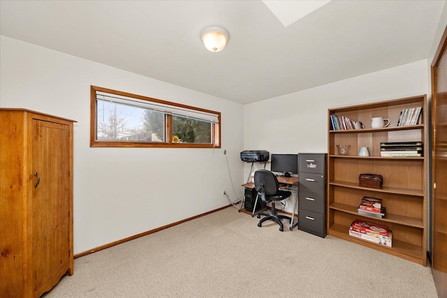 office with baseboards and light colored carpet