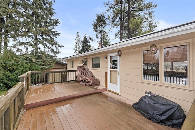 wooden deck featuring area for grilling