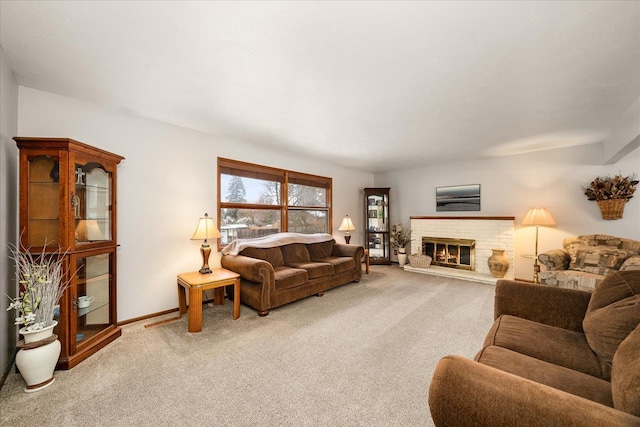 carpeted living room with a fireplace and baseboards