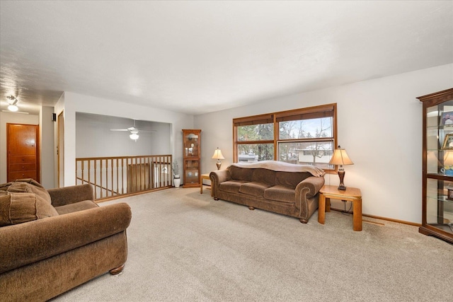 living area featuring carpet flooring and baseboards