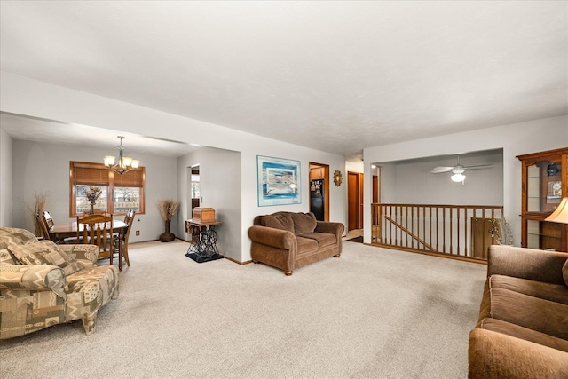 carpeted living area featuring a chandelier and baseboards